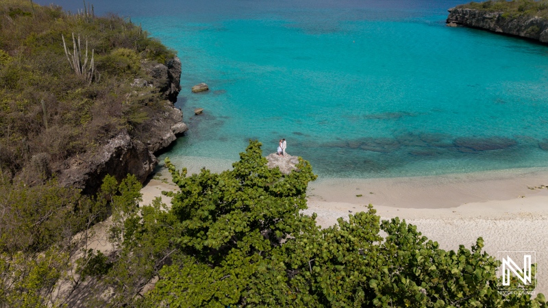 Wedding ceremony at Daaibooi Beach in Curacao with guests celebrating near the water