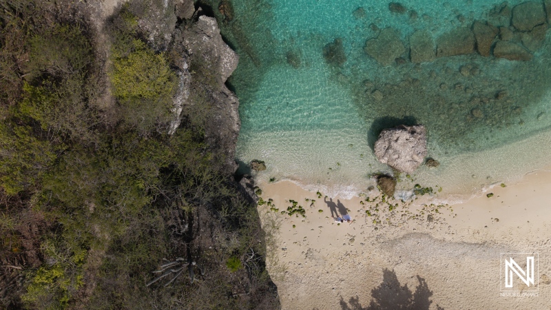 Couple celebrating wedding ceremony at Daaibooi Beach in Curacao while enjoying beautiful ocean views and sandy shores