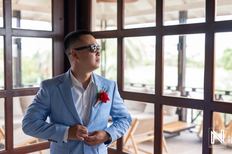 Groom preparing for a beach wedding ceremony at Kokomo Beach in Curacao on a sunny day