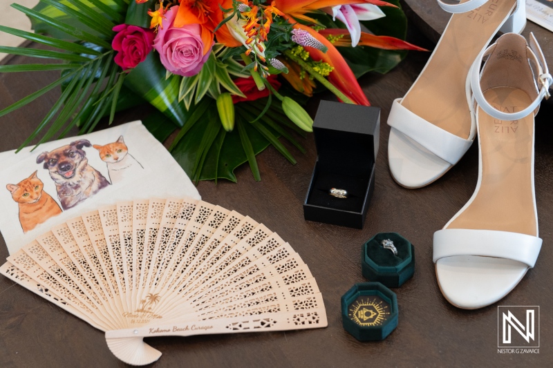 Preparation details for a beautiful wedding at Kokomo Beach, Curacao, featuring elegant shoes, stunning floral arrangements, and sentimental keepsakes