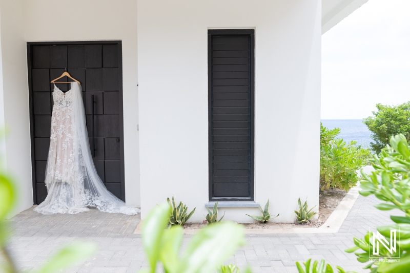Beautiful wedding dress hanging at Kokomo Beach venue in Curacao, ready for an unforgettable beach ceremony
