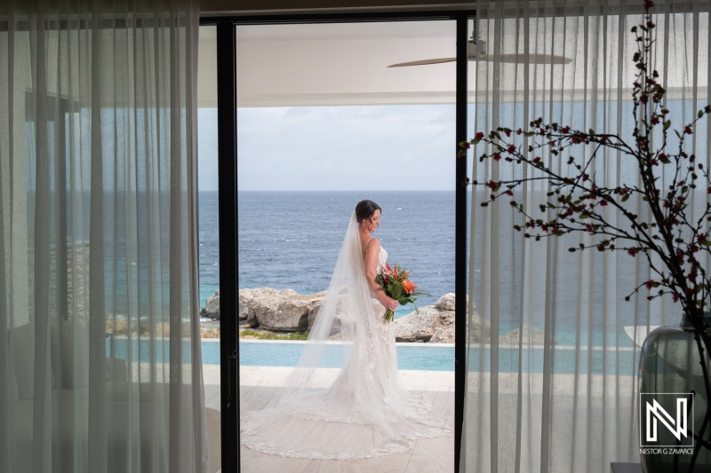 Bridal moment at Kokomo Beach in Curacao with stunning ocean backdrop during a romantic wedding celebration