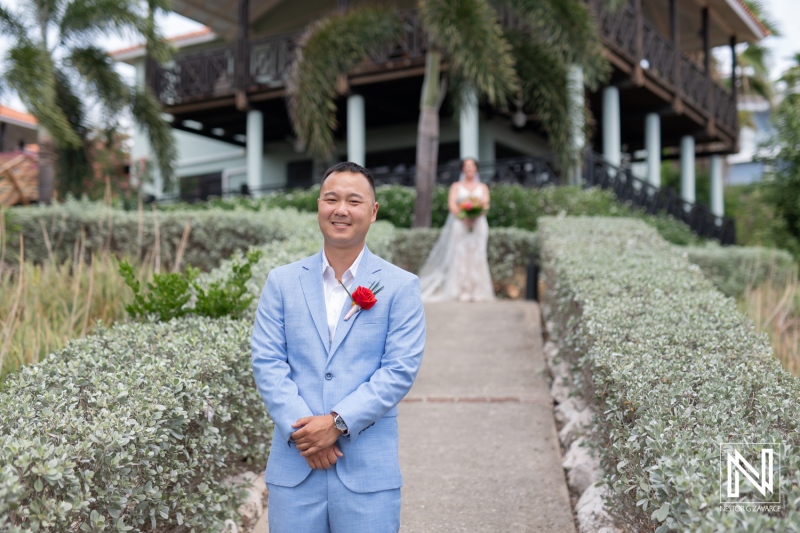 Wedding ceremony at Kokomo Beach in Curacao with groom waiting at the altar while bride approaches