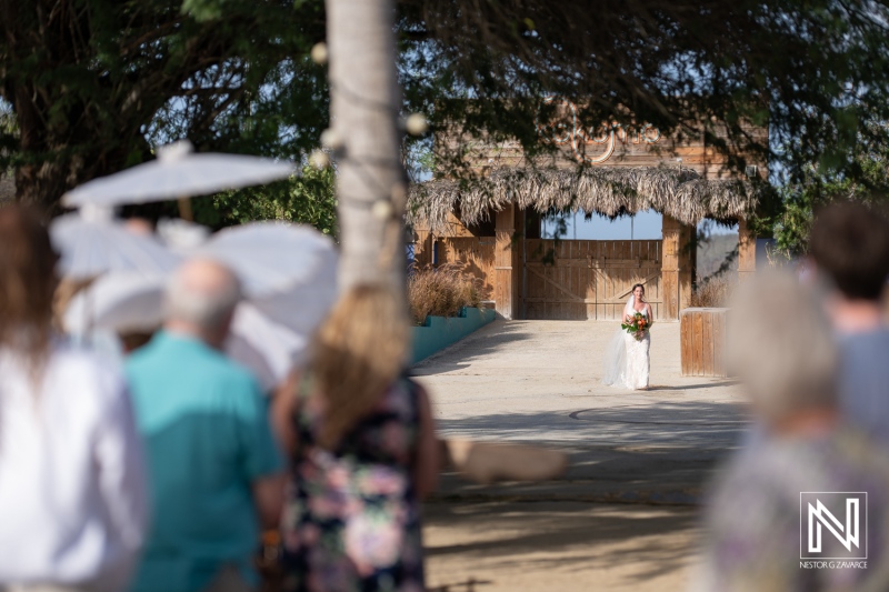 Celebration of love at Kokomo Beach in Curacao features stunning backdrop and heartfelt moments during the wedding ceremony