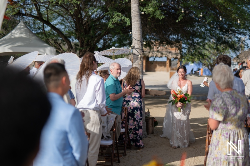 Celebration of love at Kokomo Beach, Curacao during a picturesque wedding ceremony with family and friends