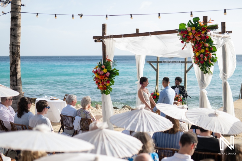 Wedding ceremony at Kokomo Beach in Curacao featuring a beautiful setup with decorated altar and sea backdrop