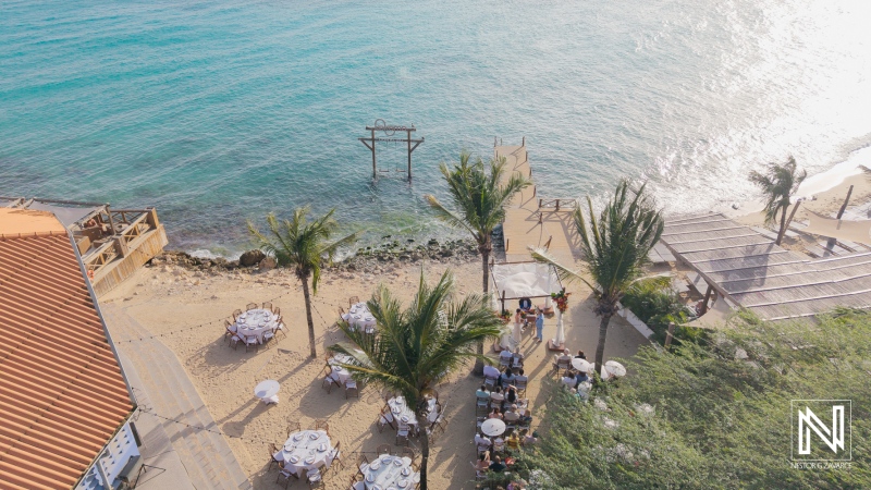 Beautiful wedding celebration at Kokomo Beach in Curacao featuring an ocean backdrop and festive atmosphere during sunset hours