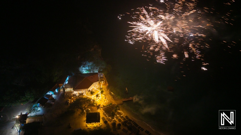 Fireworks illuminate Kokomo Beach during a joyous wedding celebration in Curacao