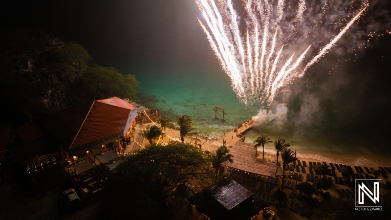Celebratory fireworks illuminate Kokomo Beach during a wedding in Curacao under the night sky for a magical experience