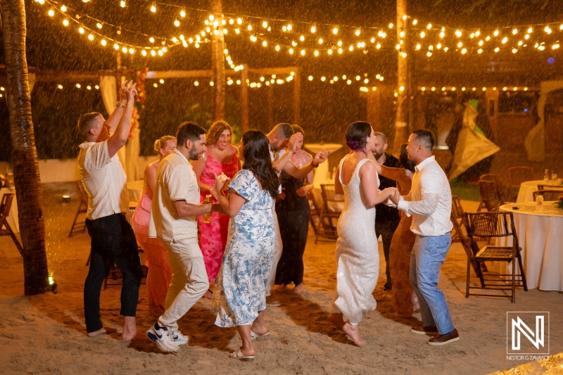 Dancing under the stars during a joyful wedding celebration at Kokomo Beach in Curacao with friends and family enjoying the moment