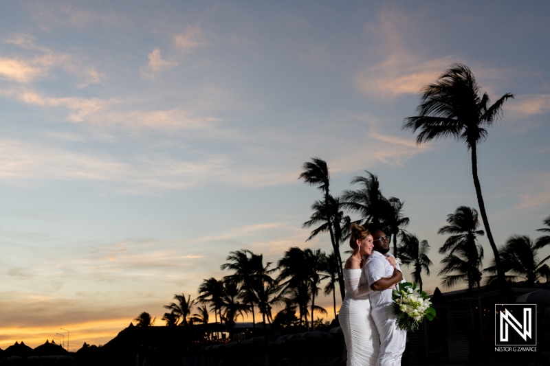 A beautiful sunset wedding ceremony on the beach with palm trees swaying in the warm breeze, capturing a couple\'s romantic moment during their celebration