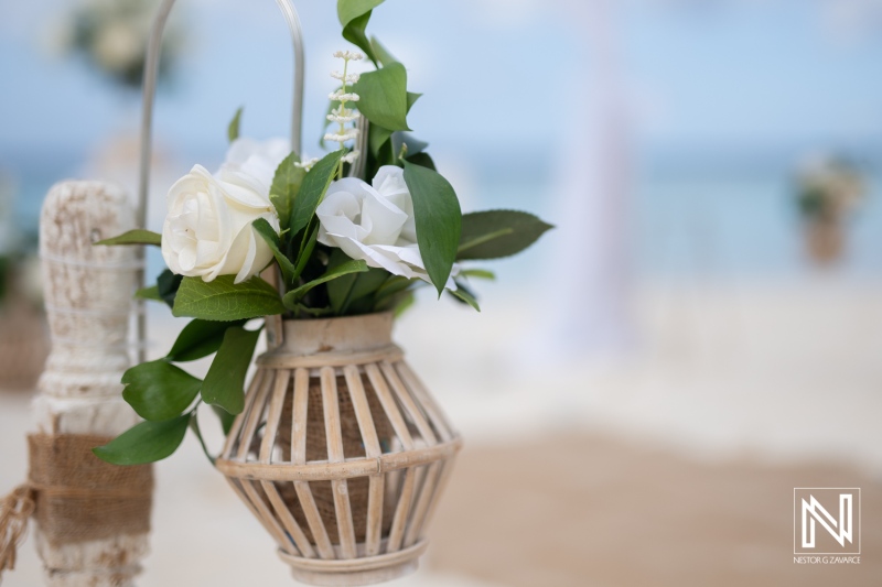 Wedding setup at Cas Abao Beach with flowers hanging in a decorative container