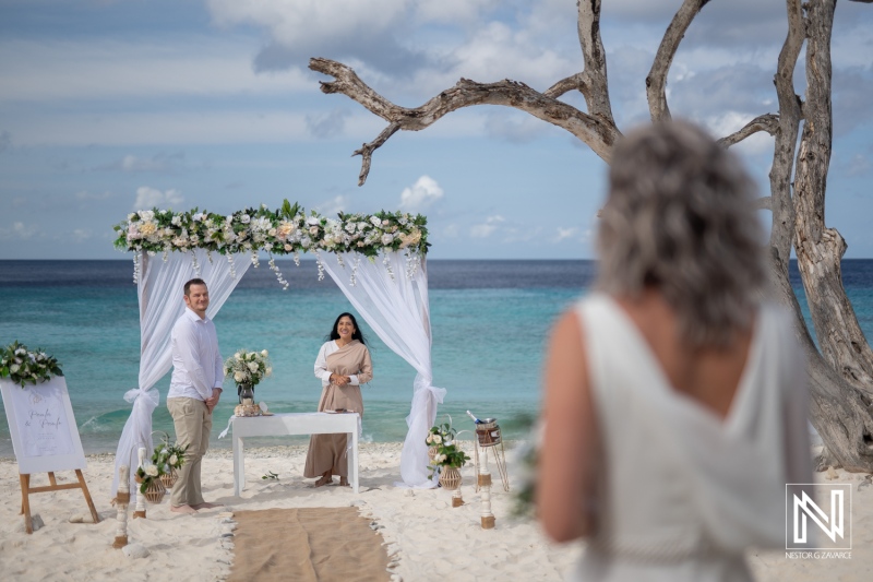 Wedding ceremony at Cas Abao Beach in Curacao with couple and guests preparing for the exchange of vows