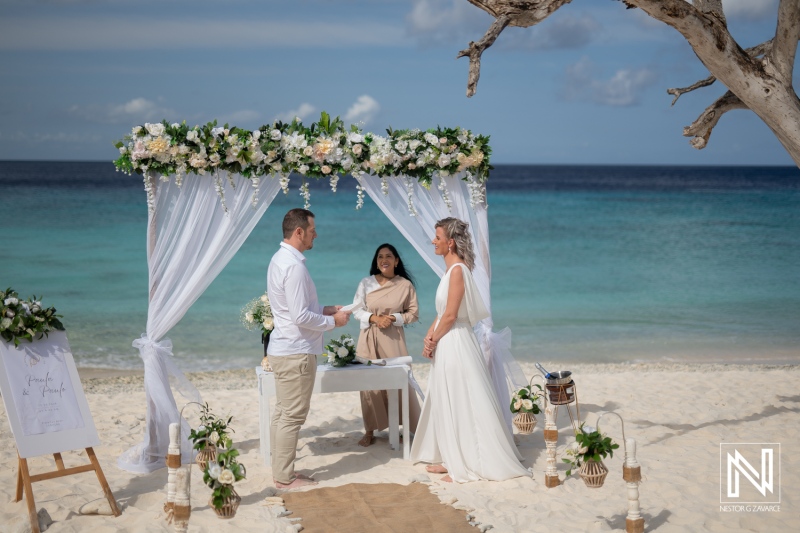 Wedding ceremony at Cas Abao Beach in Curacao between a couple with an officiant present