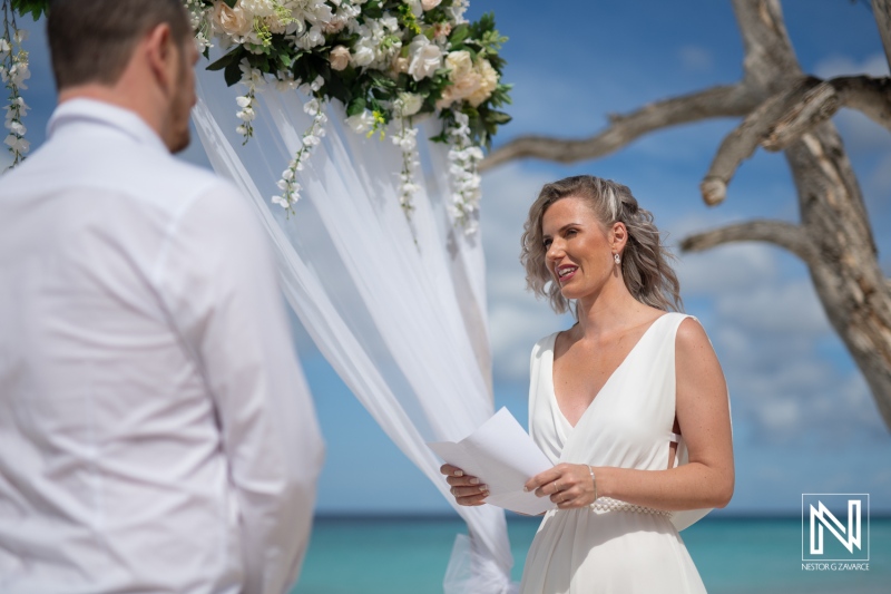 Couple exchanges vows at a wedding ceremony on Cas Abao Beach in Curacao under a bright sky