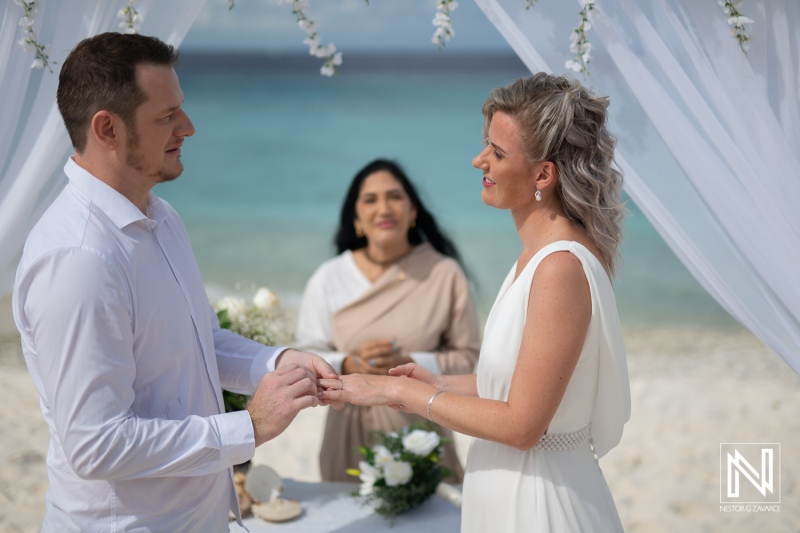 Wedding ceremony at Cas Abao Beach in Curacao with couple exchanging rings