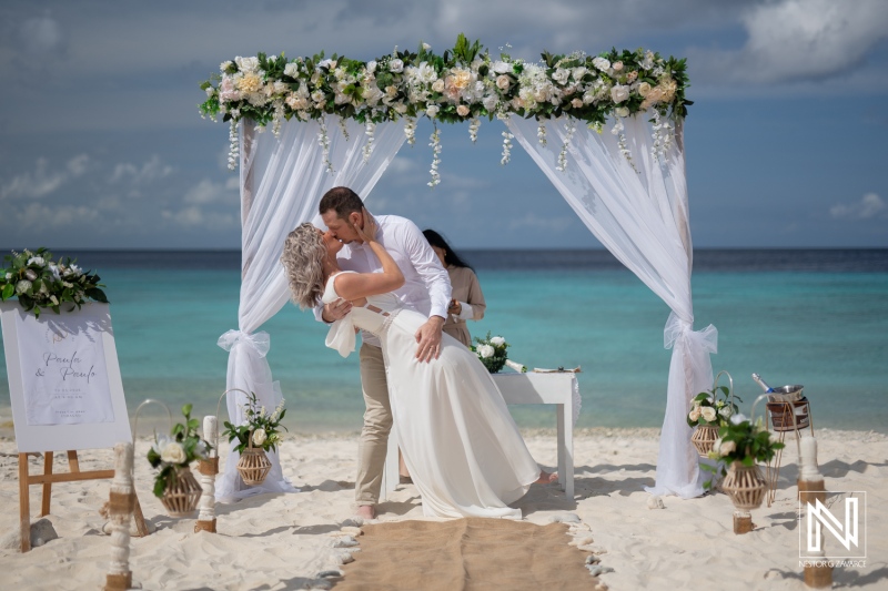 Wedding ceremony at Cas Abao Beach in Curacao with couple sharing a kiss