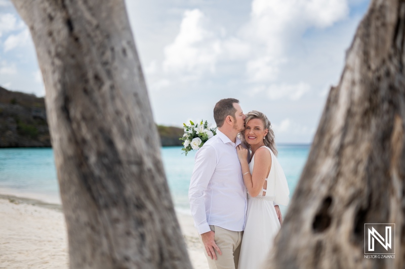 Couple shares a kiss during their wedding ceremony at Cas Abao Beach in Curacao