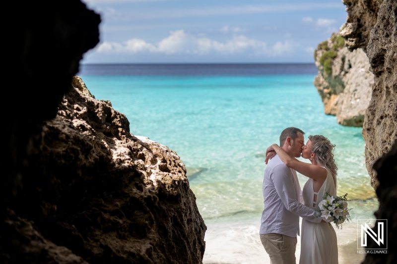 Couple shares a moment during a wedding ceremony at Cas Abao Beach in Curacao