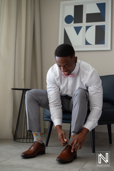 Groom getting into attire