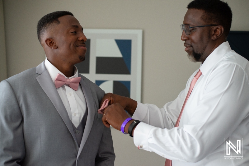 Groom getting into attire
