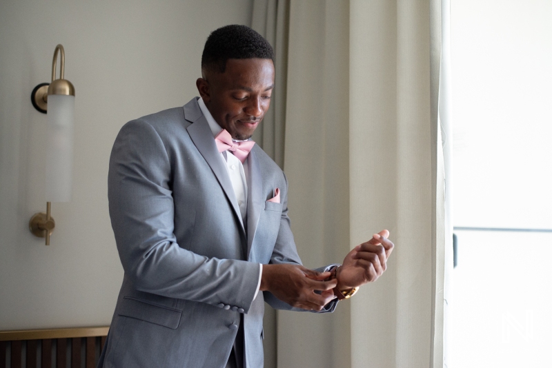 Groom getting into attire