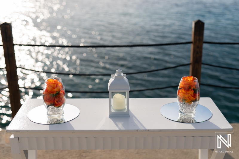 Beautifully arranged floral decor at a wedding ceremony in Curacao, showcasing vibrant colors against a stunning ocean backdrop