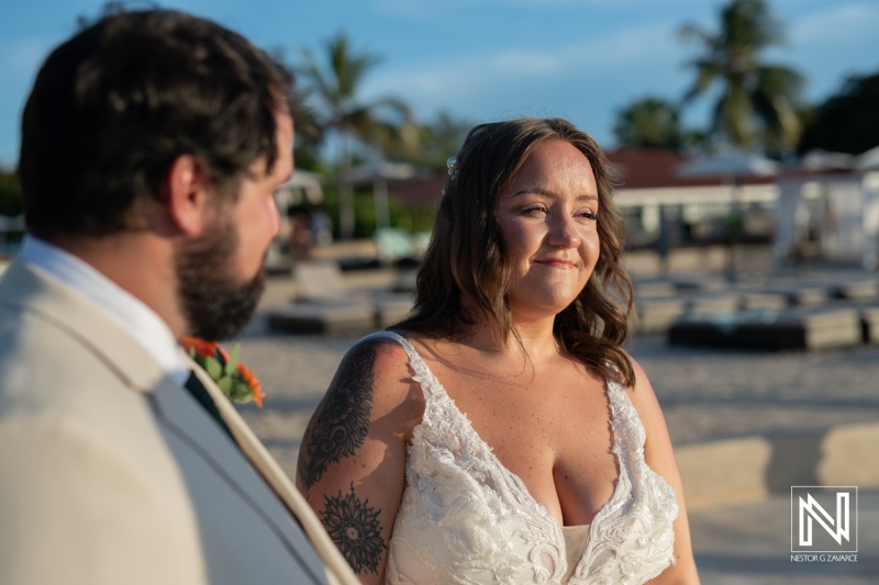 Couple exchanging vows under the warm sun at Dreams Curacao Resort, celebrating love and commitment on a beautiful wedding day