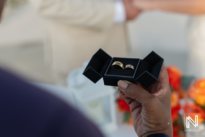 Wedding rings displayed at a beautiful outdoor ceremony in Curacao's Dreams Curacao Resort