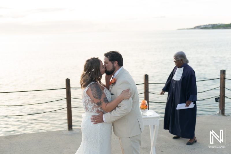 Couple exchanges vows at a romantic wedding ceremony in Curacao, celebrating love at Dreams Curacao Resort by the water