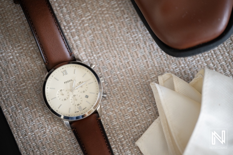 Wedding details at Renaissance Wind Creek Curacao Resort with watch, shoes, and accessories on display
