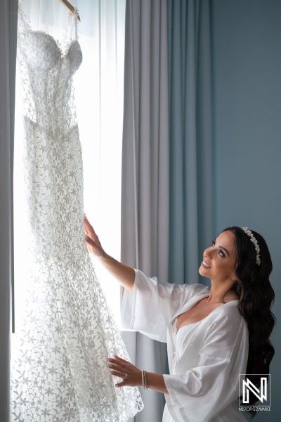 Bride admires her wedding dress at Renaissance Wind Creek Curacao Resort before the ceremony