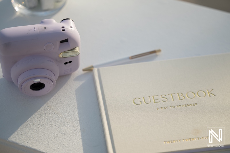 Wedding guestbook and camera at Renaissance Wind Creek Curacao Resort during a wedding celebration