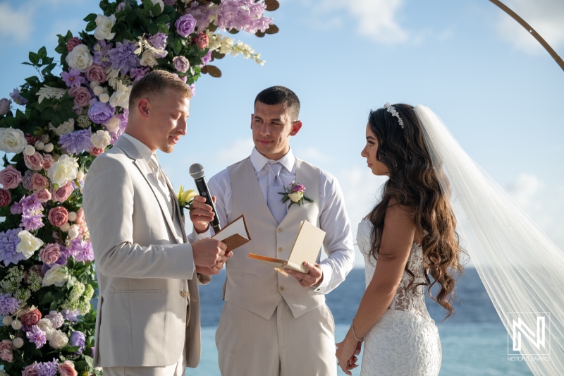 Wedding ceremony at Renaissance Wind Creek Curacao Resort with vows and flowers