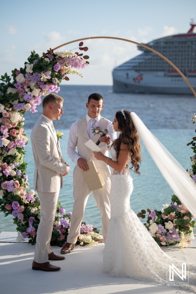 Couple exchanges vows during wedding ceremony at Renaissance Wind Creek Curacao Resort by the ocean