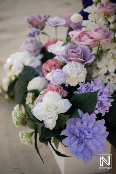 Flowers at a wedding ceremony at Renaissance Wind Creek Curacao Resort while guests gather for the celebration in Curacao