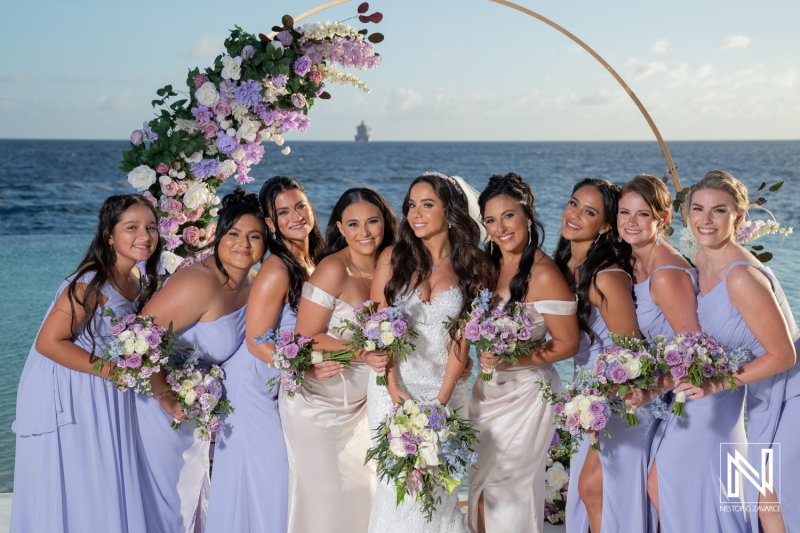 Wedding celebration at Renaissance Wind Creek Curacao Resort with bride and bridesmaids near the ocean