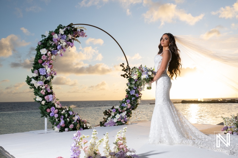 Wedding ceremony taking place at Renaissance Wind Creek Curacao Resort on the beach during sunset