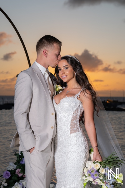 Couple celebrates wedding at Renaissance Wind Creek Curacao Resort during sunset near the beach