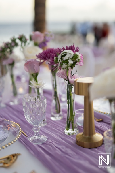 Wedding decor with floral arrangements at Renaissance Wind Creek Curacao Resort near the beach during sunset