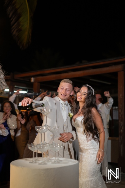 Wedding celebration at Renaissance Wind Creek Curacao Resort with champagne pouring and joyful guests