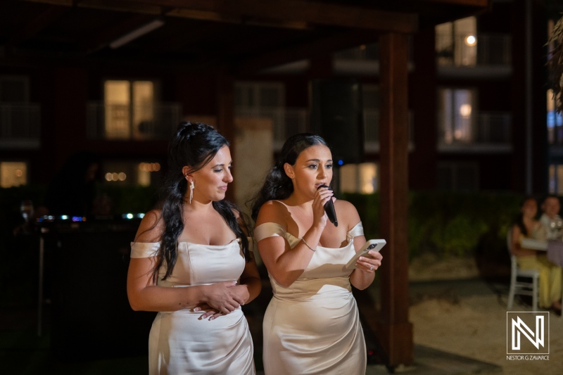 Two women speak at a wedding celebration at Renaissance Wind Creek Curacao Resort during the night