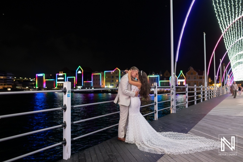 Couple shares a kiss at night during their wedding celebration at Renaissance Wind Creek Curacao Resort
