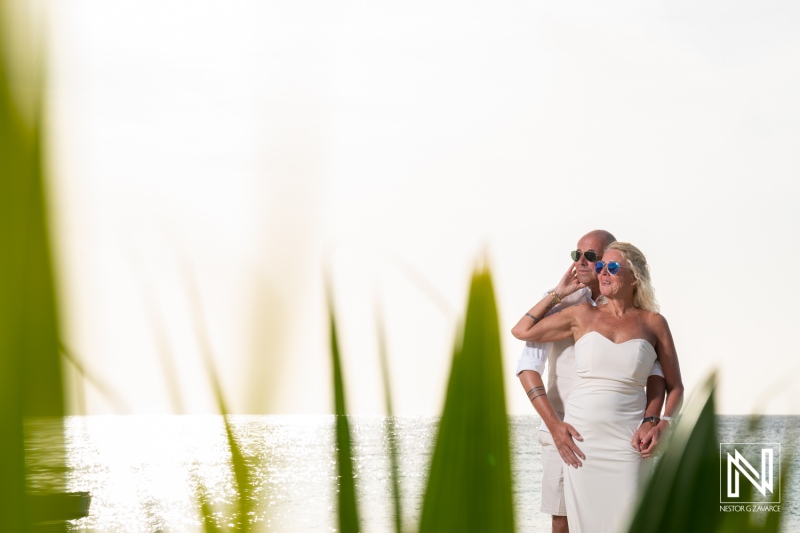 Couple enjoys wedding moment at Daaibooi Beach in Curacao during sunset