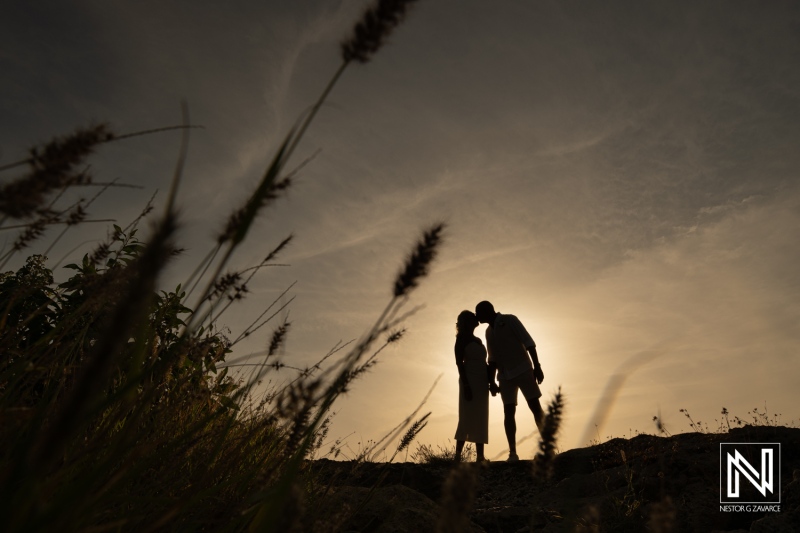 Couple shares a kiss at Daaibooi Beach during their wedding ceremony in Curacao at sunset