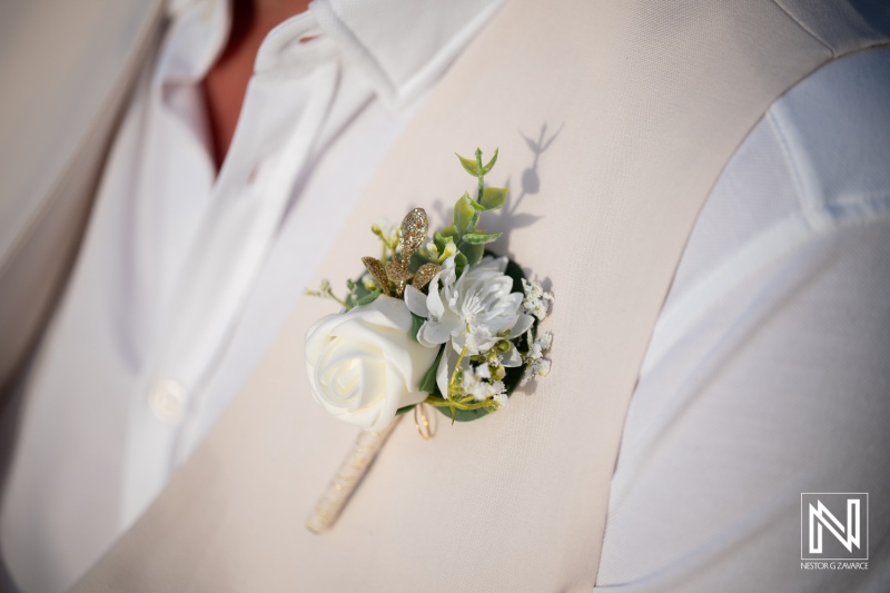 Couple celebrates wedding ceremony at Daaibooi Beach in Curacao with floral details