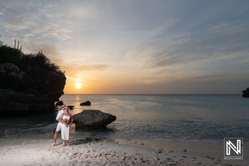 Wedding ceremony at Daaibooi Beach in Curacao with sunset as the background