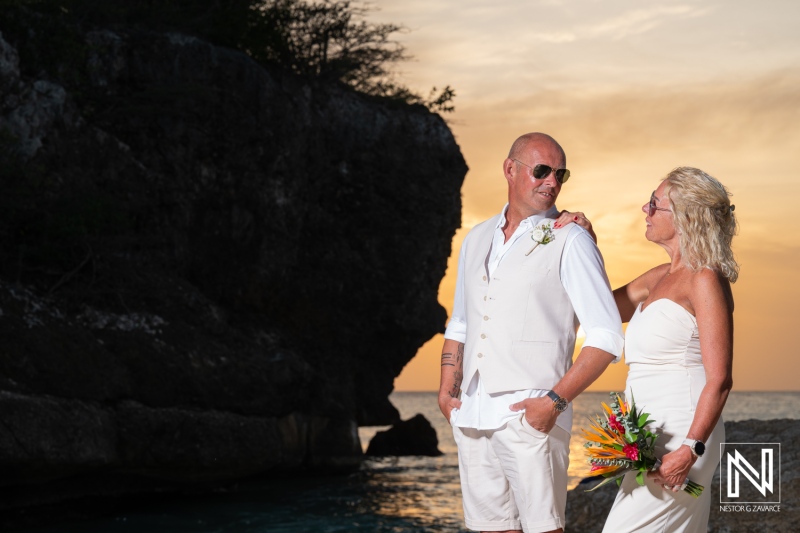 Wedding ceremony at Daaibooi Beach in Curacao during sunset with a couple standing together