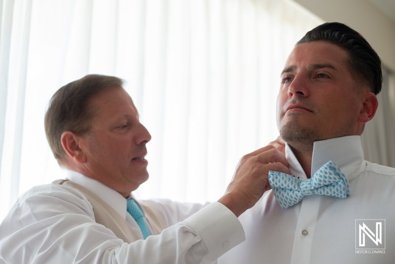 Groom getting into attire