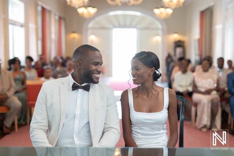 A joyful couple exchanges smiles during their wedding ceremony in an elegant venue filled with family and friends celebrating their special day in the afternoon light